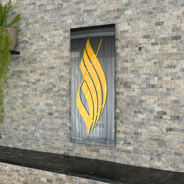 Vertical Allah calligraphy tempered glass wall art with Gold Acrylic script on black glass, on a stone wall