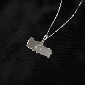 Silver Turkiye map pendant with crescent and star hanging at an angle on a fine chain