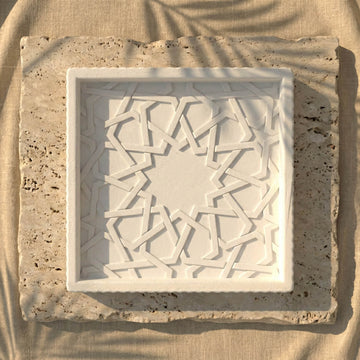 Alhambra Mexuar Pattern stone relief tray centered on a stone slab, straight-down view