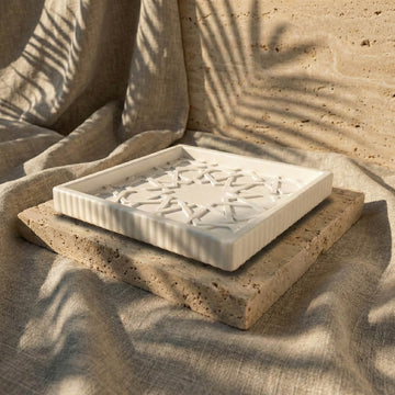 Alhambra Mexuar Pattern stone relief shown from a low angle on a stone slab, with its ribbed white edge