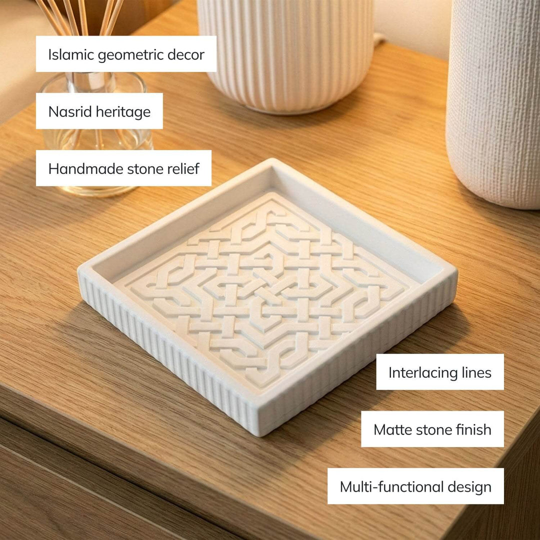 Decorative stone relief with text labels on a wooden surface