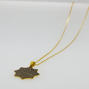 Gold octagonal Ayatul Kursi necklace laid flat with the pendant turned on its side