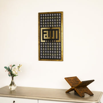 Gold 99 Names of Allah Kufic wall art on a cream wall above a console with a Quran stand