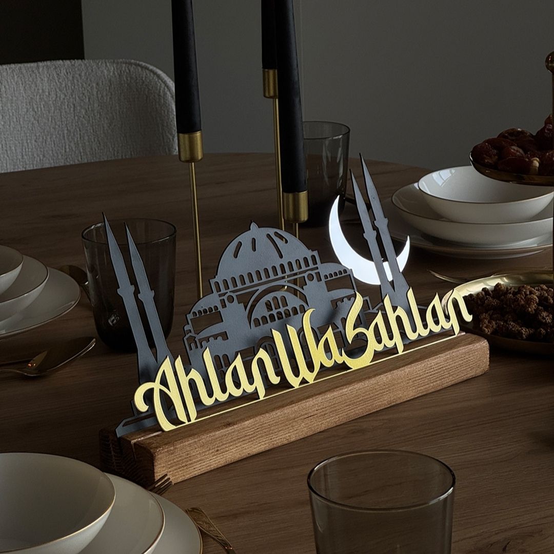 Decorative nameplate with architectural design on a wooden stand on a dining table.