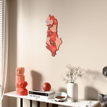 Flag colored Albania wooden wall map beside a sheer curtain, angled view