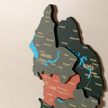 Close-up of the Sage Albania wooden wall map with layered regions and printed names