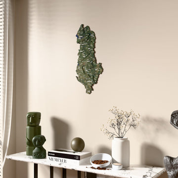 Satellite Albania wooden wall map beside a sheer curtain, angled view
