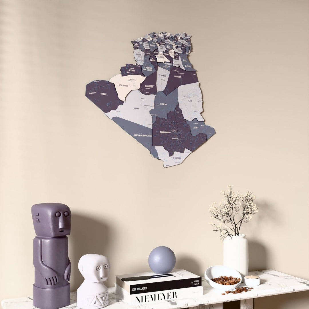 Nimbus Algeria wooden wall map on a beige wall above a console with figurines