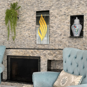 Gold Acrylic Allah calligraphy on black tempered glass above a fireplace with a light blue armchair