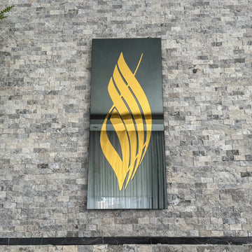 Close view of Gold Acrylic Allah calligraphy on black tempered glass, showing the curved script