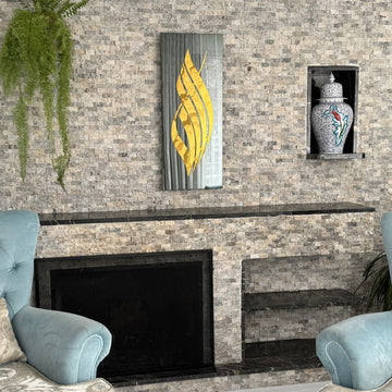 Gold Acrylic Allah calligraphy on black tempered glass above a stone fireplace, seen from the left