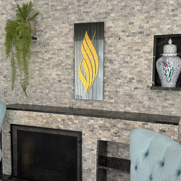 Gold Acrylic Allah calligraphy on black tempered glass beside a stone wall niche with a ceramic jar