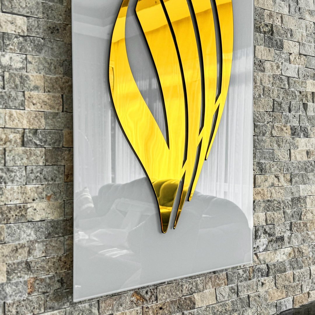 Close-up of Gold Acrylic Allah calligraphy on Solid White tempered glass, angled against stone