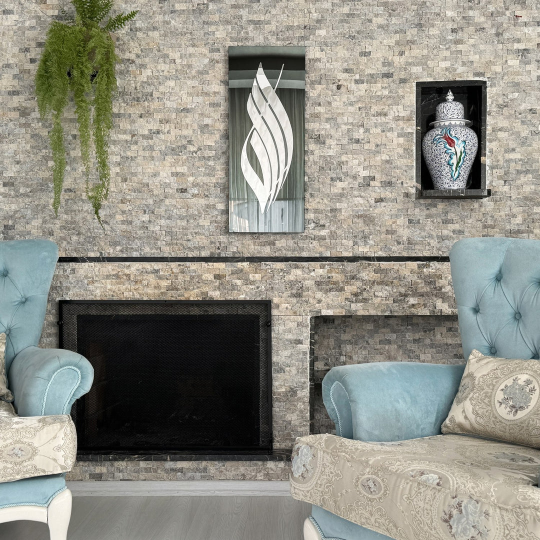 Silver Acrylic Allah calligraphy on black tempered glass above a stone fireplace, wide room view