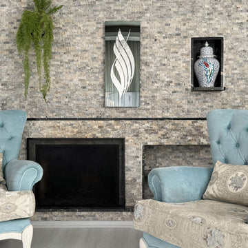 Silver Acrylic Allah calligraphy on black tempered glass above a stone fireplace, wide room view
