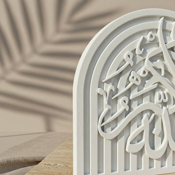 Macro view of the Allah-u Akbar relief calligraphy on the stone arch plaque corner