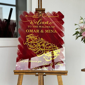 Glass Nikkah wedding sign with Love and Mercy verse in gold on red, front view on a wooden easel