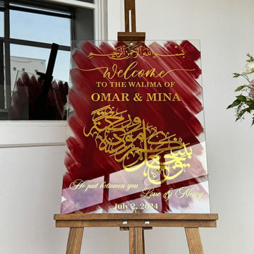 Glass wedding sign with Love and Mercy calligraphy in gold, view from the right on an easel