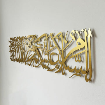 Gold metal Assalamu Alaikum calligraphy, close side angle showing its depth from the wall