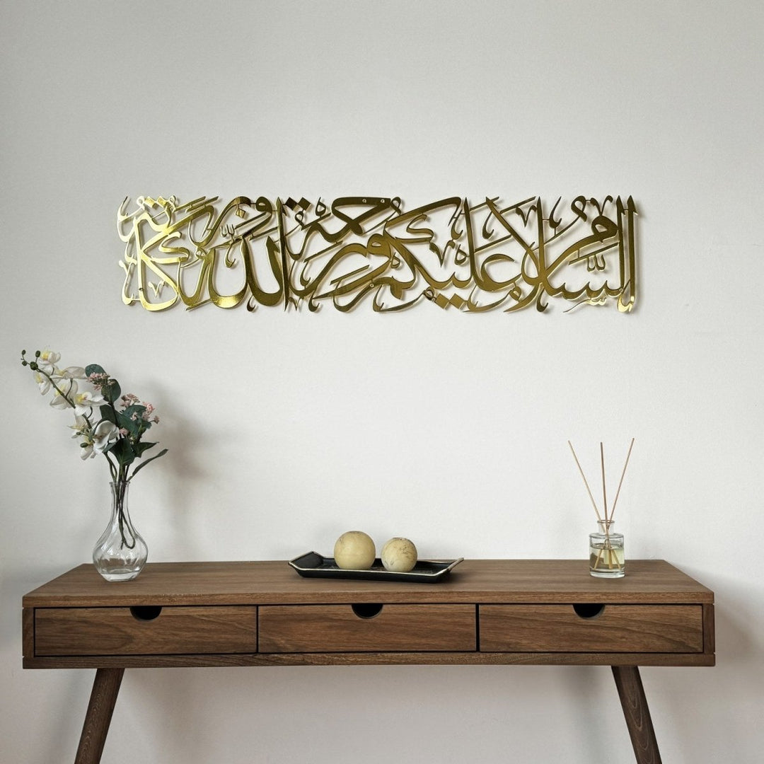 Shiny gold Assalamu Alaikum Wa Rahmatullahi Wa Barakatuh metal wall art above a wooden console