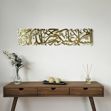 Shiny gold Assalamu Alaikum Wa Rahmatullahi Wa Barakatuh metal wall art above a wooden console