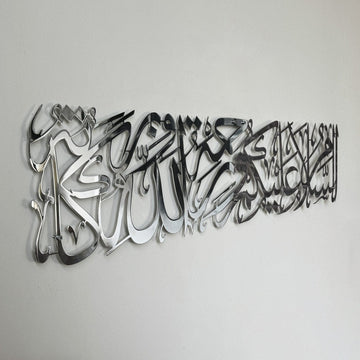 Shiny silver metal Assalamu Alaikum calligraphy, close side angle with a mirror-like surface