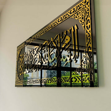 Gold border and calligraphy on the black tempered glass, angled close view showing the reflective surface