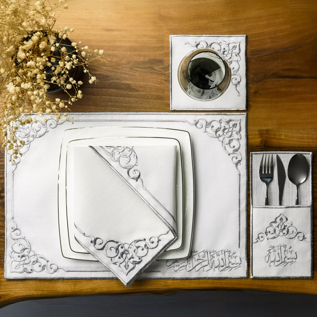 Silver Basmala dining set for one place with plates, folded napkin, coaster and cutlery pouch, top view
