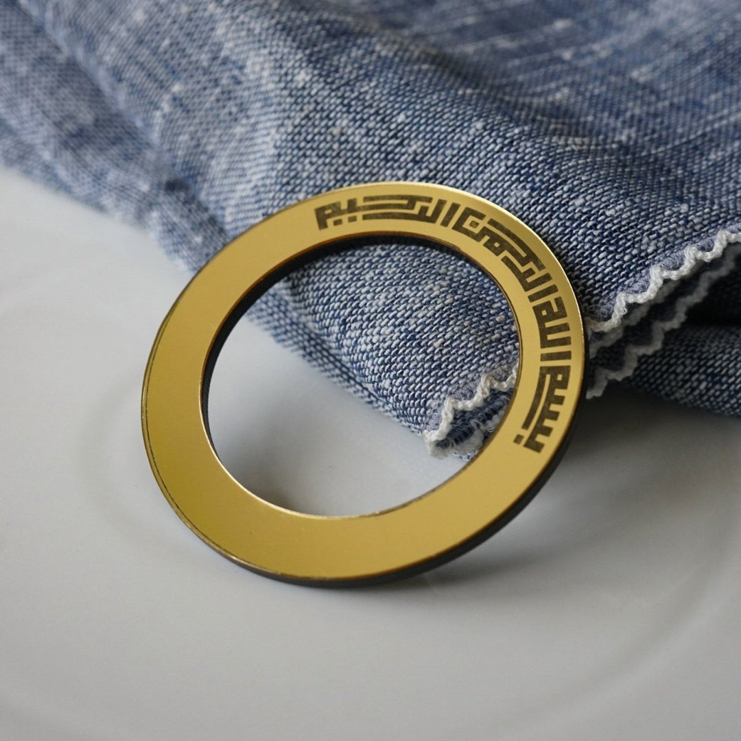 Bismillah Kufic circular napkin holder on a set table