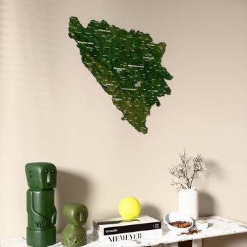 Satellite Bosnia and Herzegovina wooden wall map on a beige wall above a console with figurines