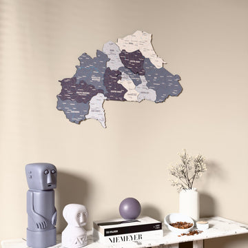 Nimbus Burkina Faso wooden wall map on a beige wall above a console with figurines