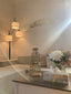 Silver calligraphy wall art and a calligraphy table piece in a sunlit living room