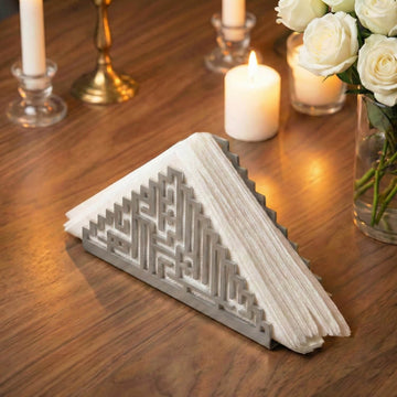 Bismillah Kufic metal napkin holder in silver on a set table