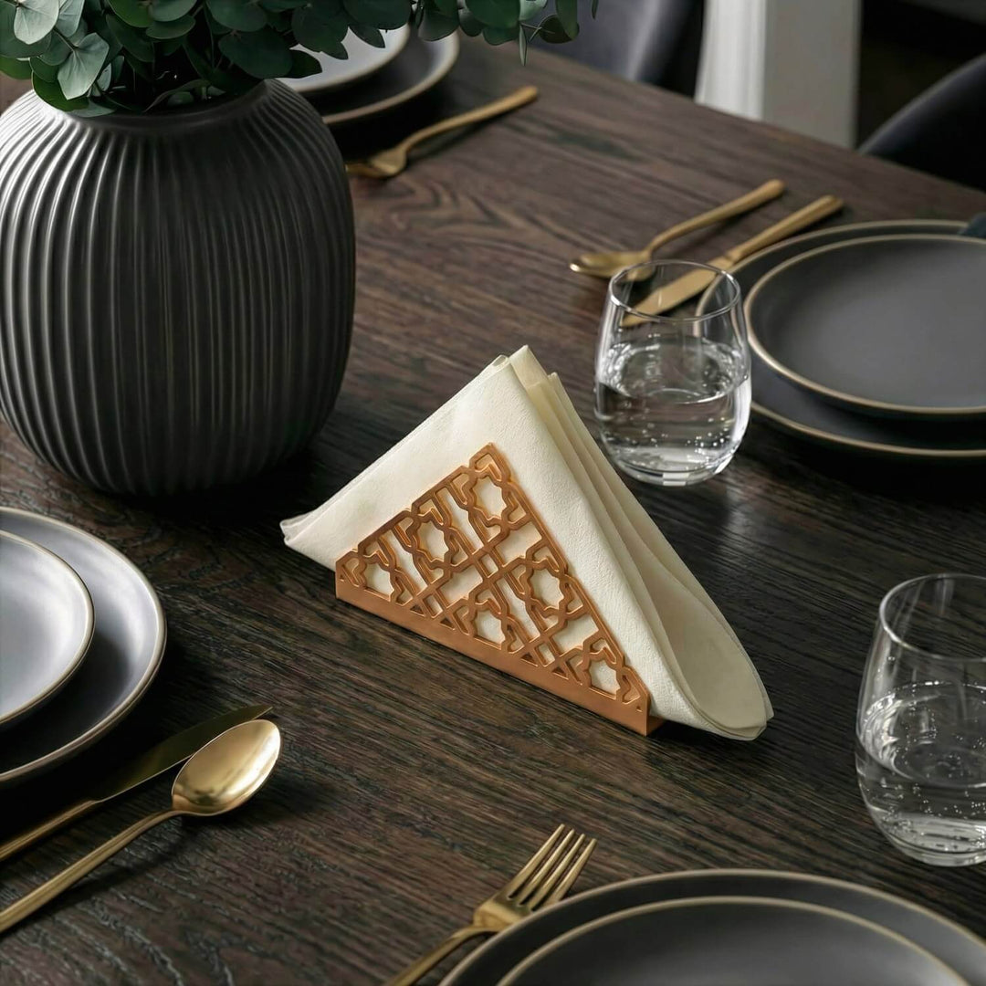 Geometric metal napkin holder in copper on a set table