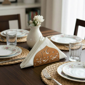 Saha w Afia metal napkin holder in copper on a set table
