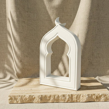 White stone mihrab arch decor with crescent moon on a travertine slab, front view