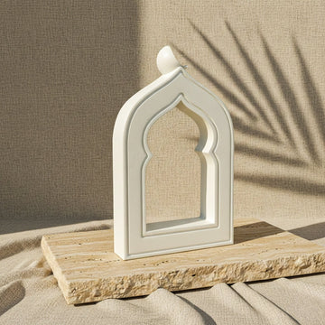 Mihrab stone arch seen from an angle on a travertine slab, showing the arch's depth