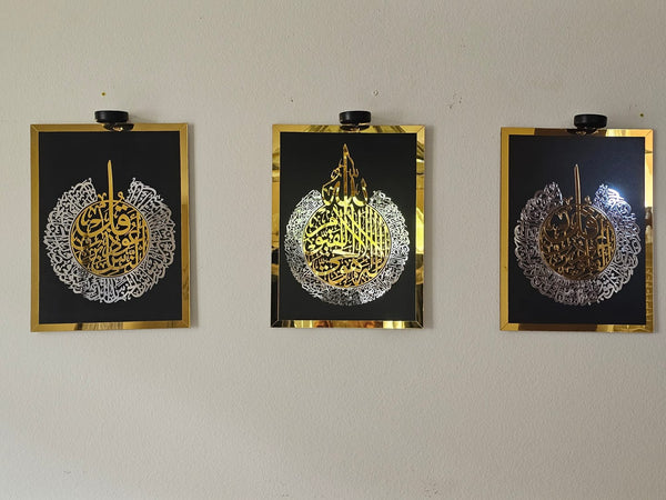 Customer photo of three framed gold and silver calligraphy panels under lights