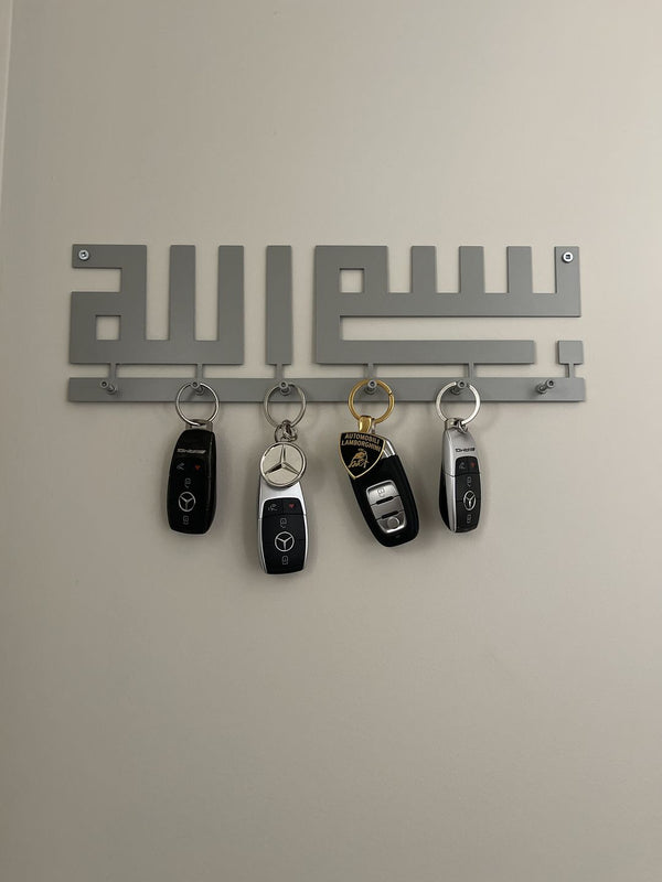 Customer photo of a silver Bismillah key holder with car keys