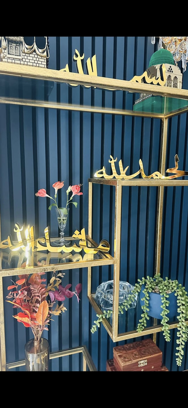 Customer photo of gold calligraphy table decor on gold shelves against a blue wall