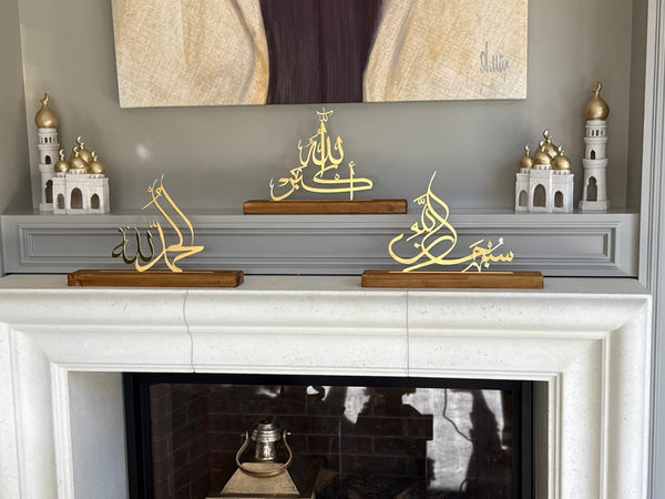 Customer photo of gold calligraphy table decor arranged on a fireplace mantel