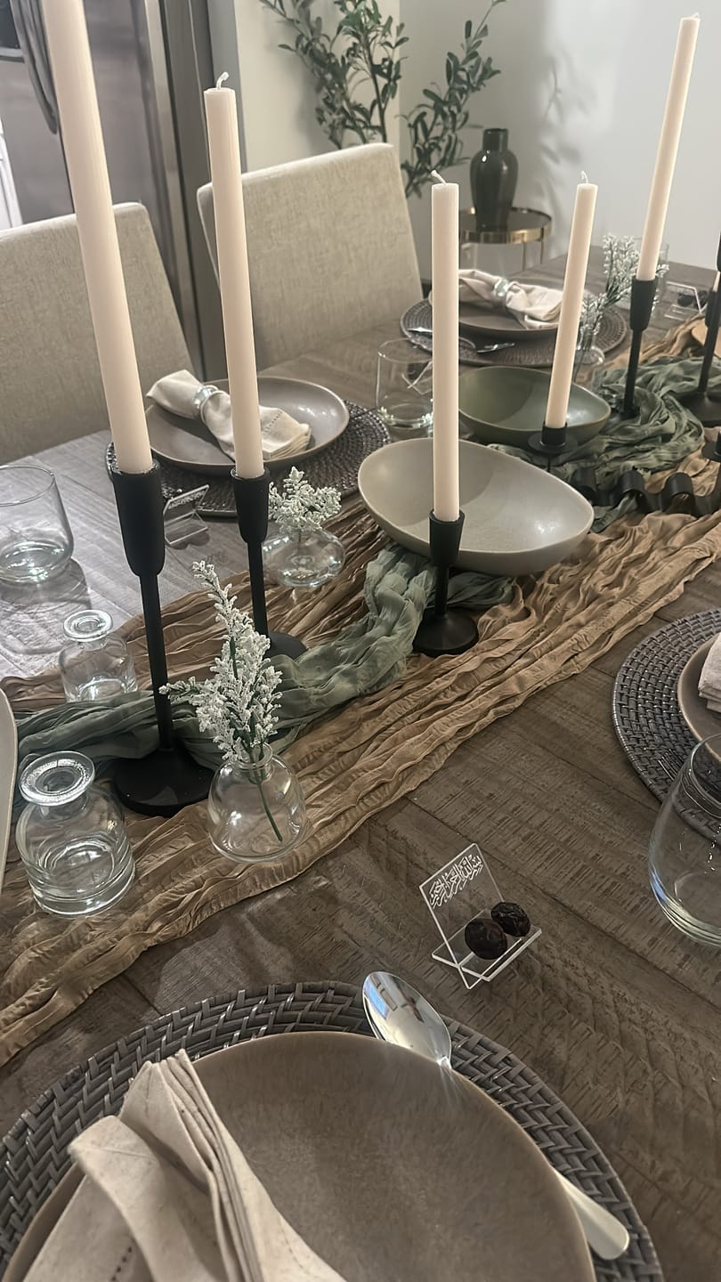 Customer photo of a dining table set with black candlesticks and a wooden runner