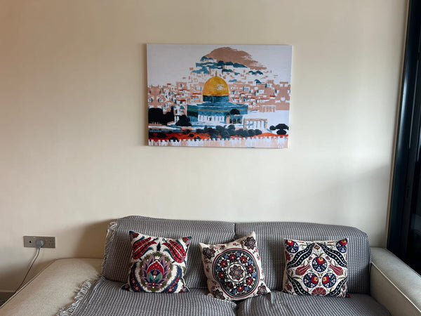 Customer photo of a colorful Dome of the Rock canvas above a gray sofa