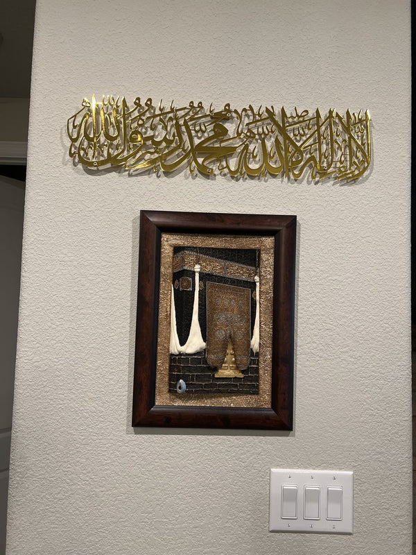 Customer photo of gold Kalima calligraphy above a framed Kaaba picture