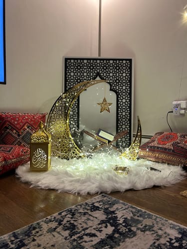 Customer's Ramadan corner with a gold crescent, lantern and mihrab panel over a fur rug