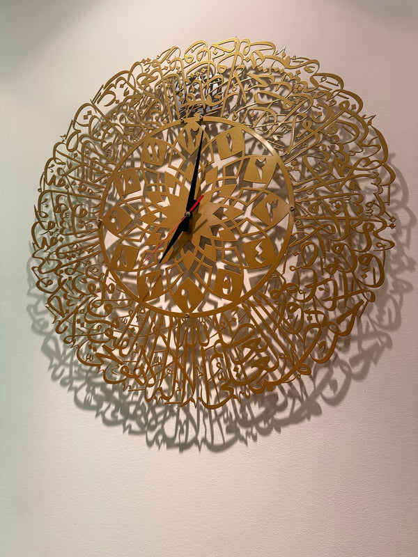 Customer photo of a round gold Arabic calligraphy wall clock casting shadows
