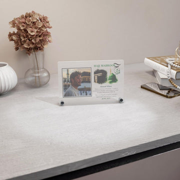 Design 1 Hajj Mabroor table decor with a man's photo, wide view on a desk