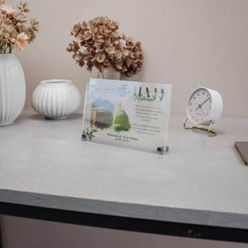 Design 3 Hajj Mabroor table decor on a white desk, wide view with a clock
