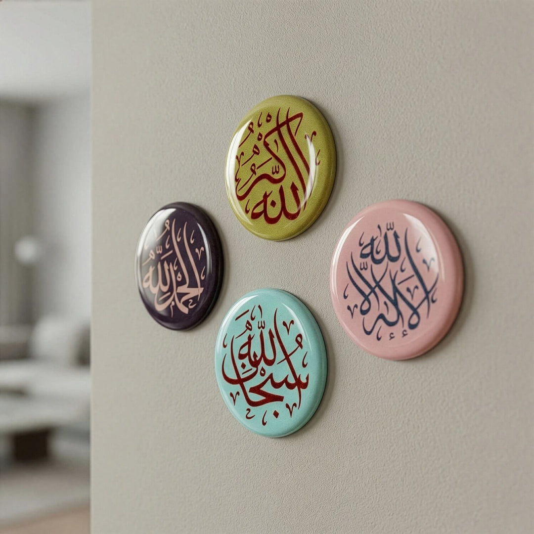 Four colorful buttons with Arabic calligraphy on a wall.