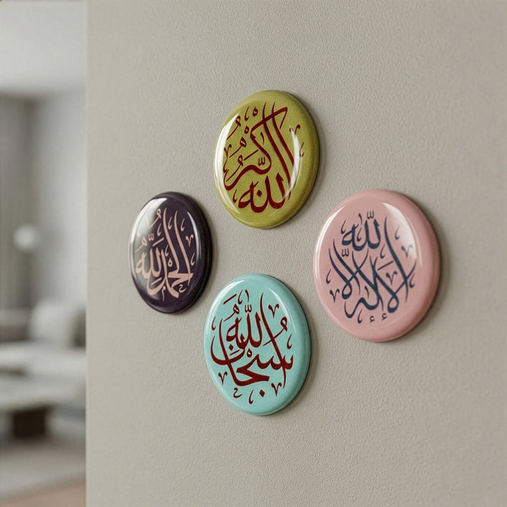 Four colorful buttons with Arabic calligraphy on a wall.